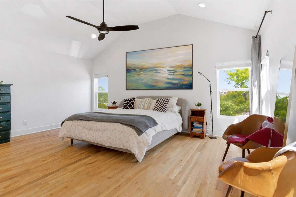 LARGE primary suite with downtown views and a vaulted ceiling.