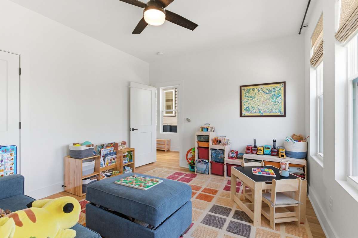 Main-floor bedroom with flexible use as a home office, bonus room, or playroom.