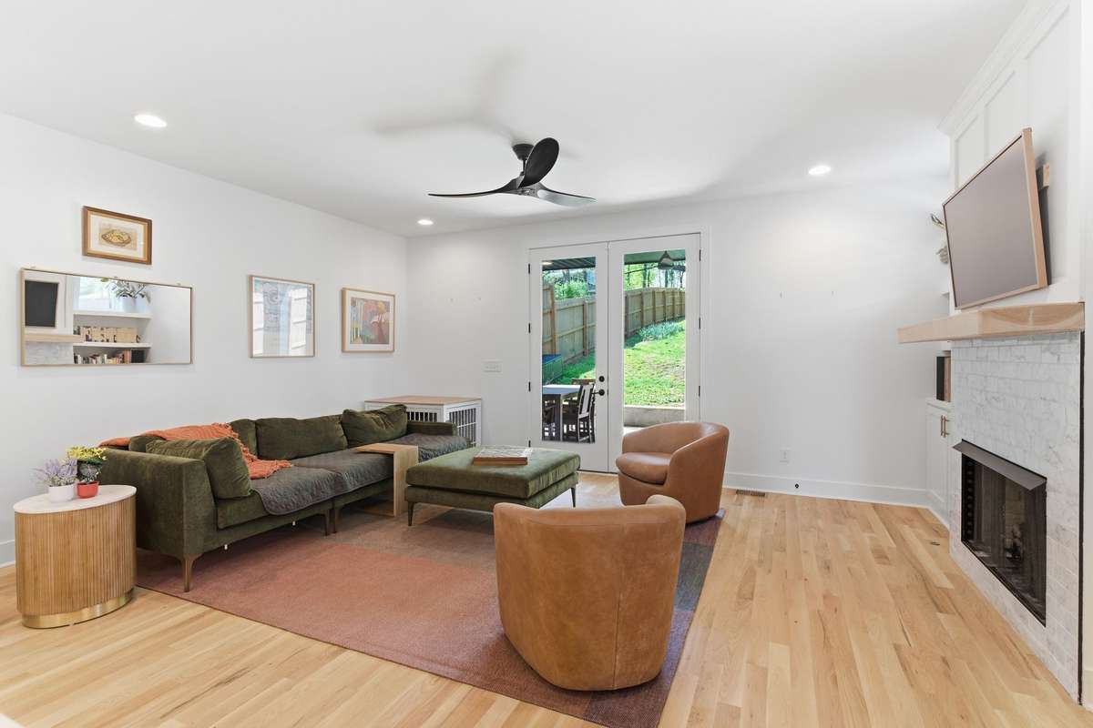 Relax in this inviting living room filled with natural light, featuring a cozy gas fireplace and plenty of space to unwind or entertain.