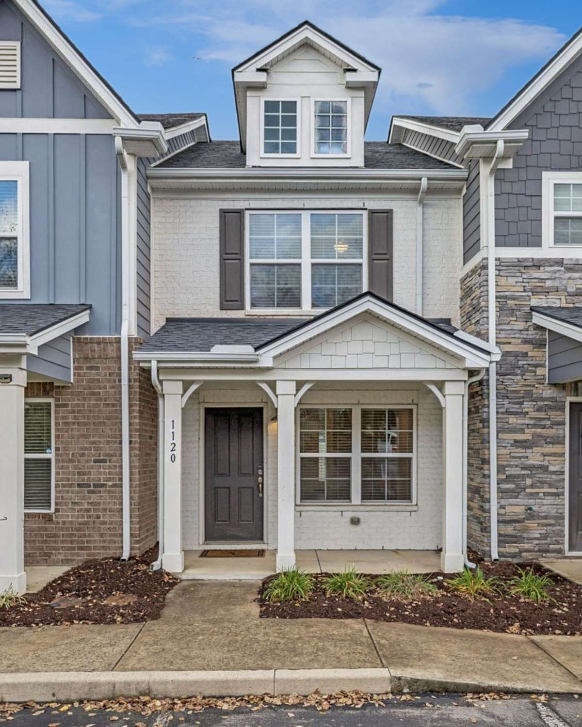Another view of the home’s tucked-away location, highlighting the covered patio and easy parking just steps from your front door, ideal for quick errands and seamless West Nashville living.