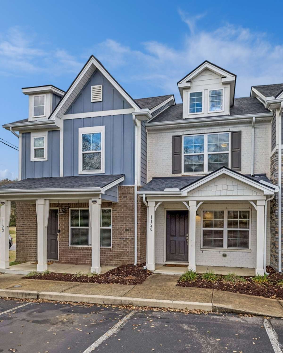 Welcoming exterior of this low-maintenance townhome, set in a charming, sidewalk-lined community. Enjoy a covered front patio and direct access to assigned and open parking right outside the unit for everyday convenience.