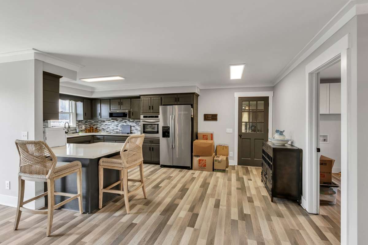 Watch TV from the kitchen as dinner is being prepared.