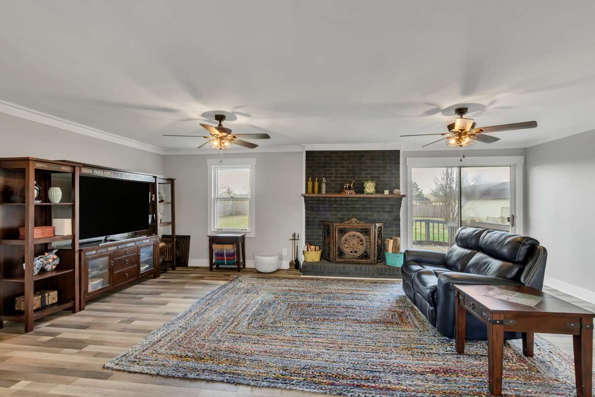 Open and inviting Great Room wit eye-catching fireplace and lots of light.