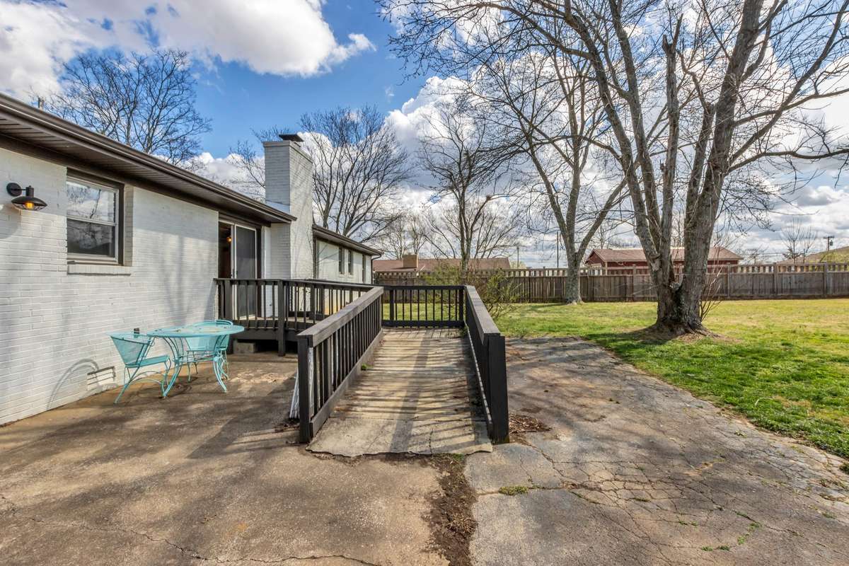Just outside the sliding glass doot , the deck and convenient ramp lead to the big backyard and patio
