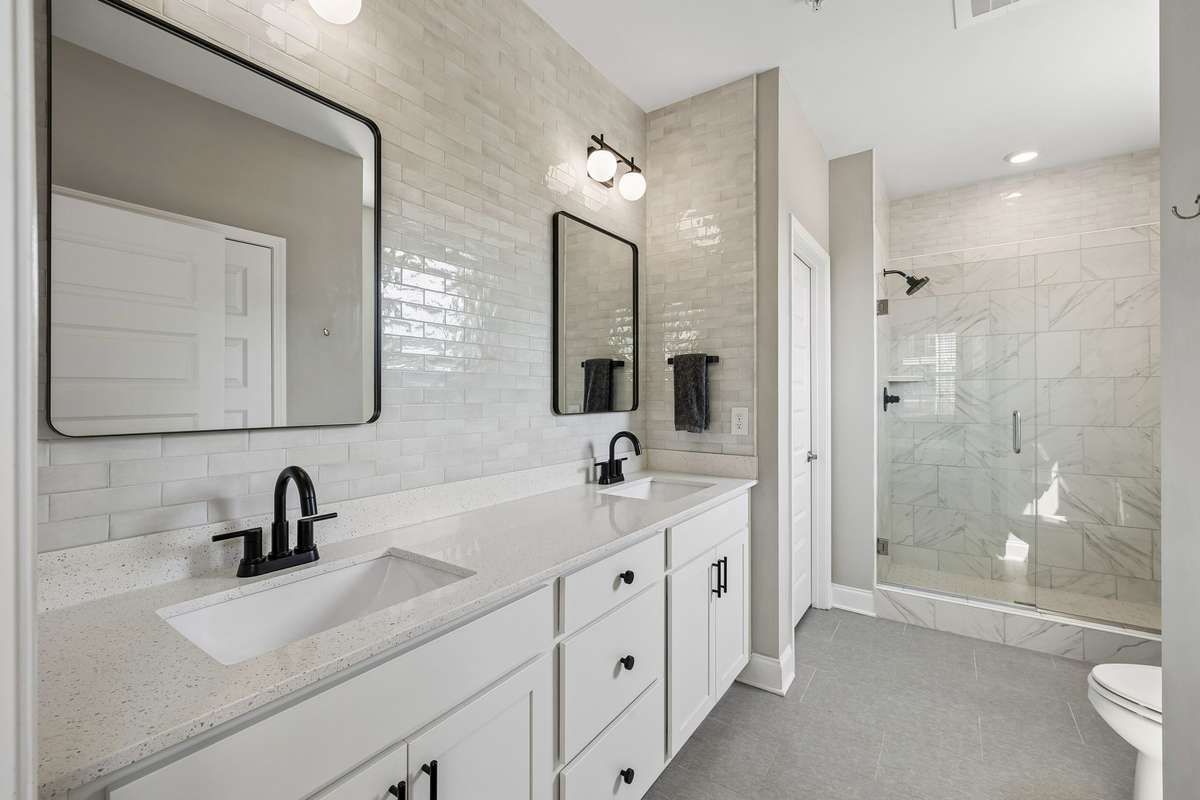 Spacious Primary Ensuite Bath with gorgeous tile to the ceiling, double vanities and a huge walk-in shower!