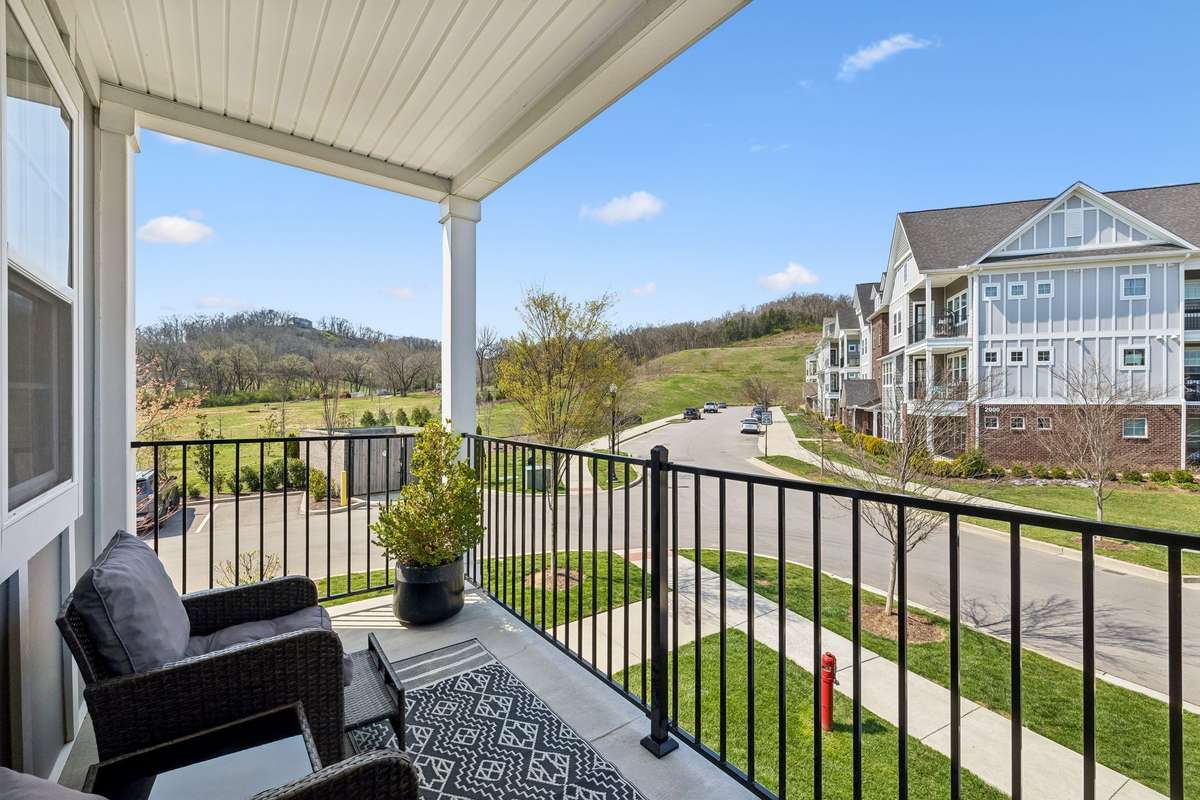Covered porch to enjoy the peaceful end unit and end building!