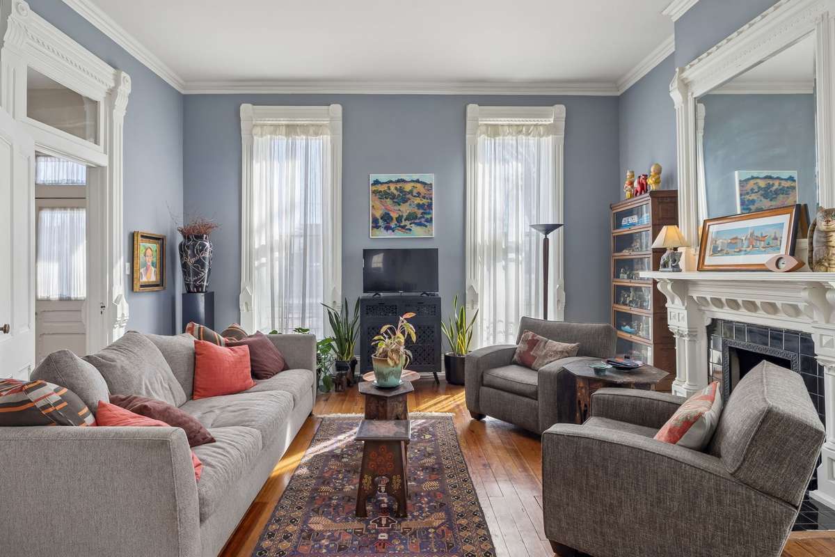 Enjoy the golden glow of sunsets in the west-facing living room with a cozy gas fireplace and an elegant transom-crowned doorway.
