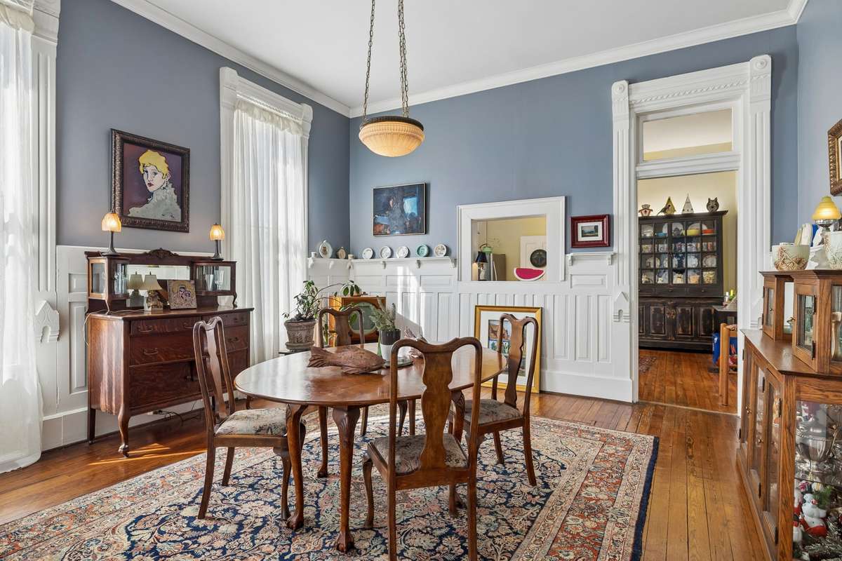 Winscotting around the dining room with a transom doorway leading into the very cool kitchen.