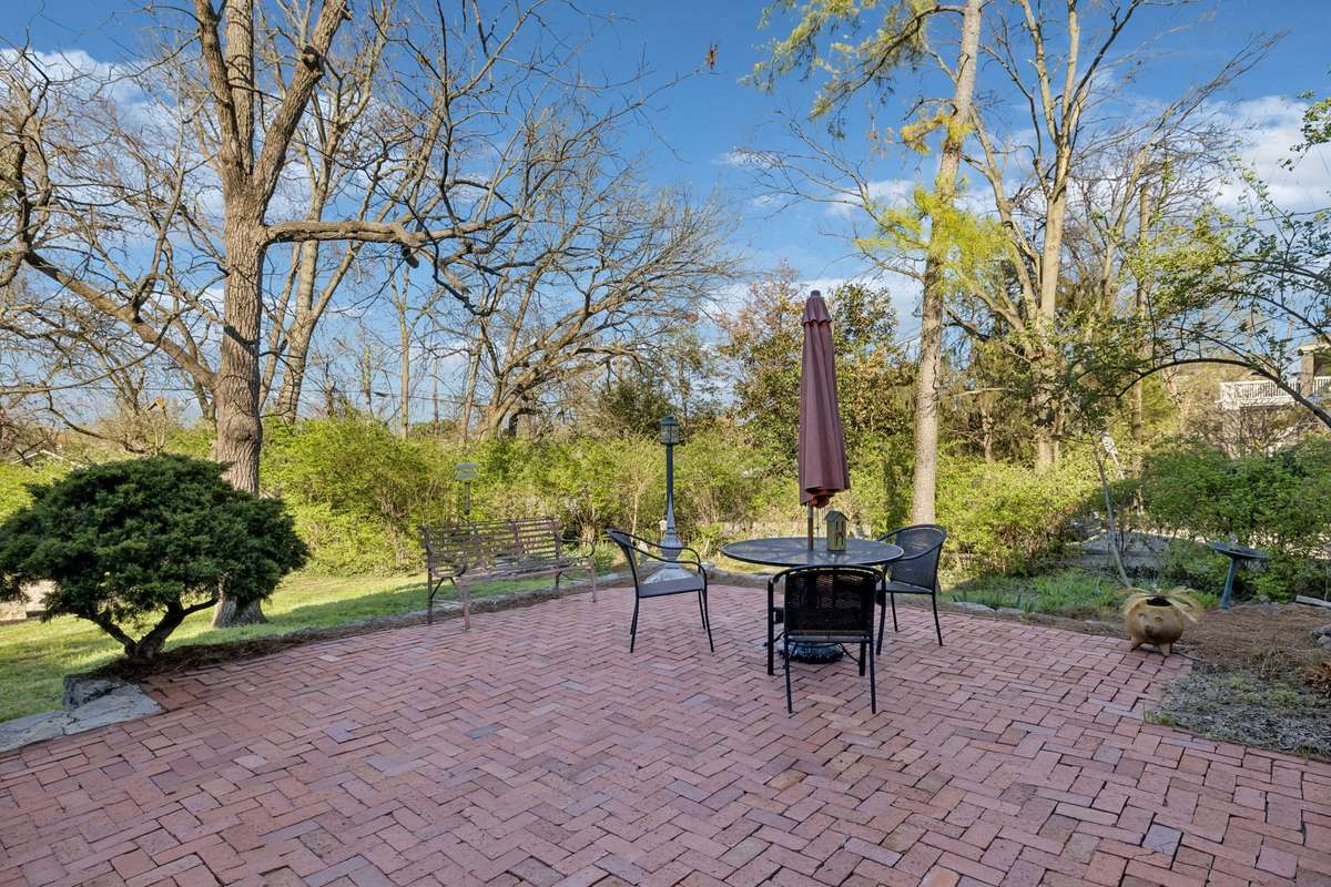 Peace and quiet as the sun shines across the back lawn and the beautiful brick area