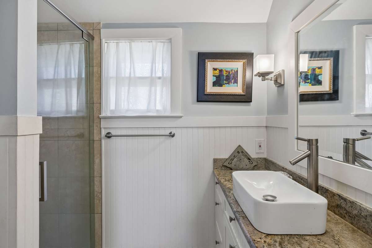 The updated primary bathroom on the first floor with a large shower