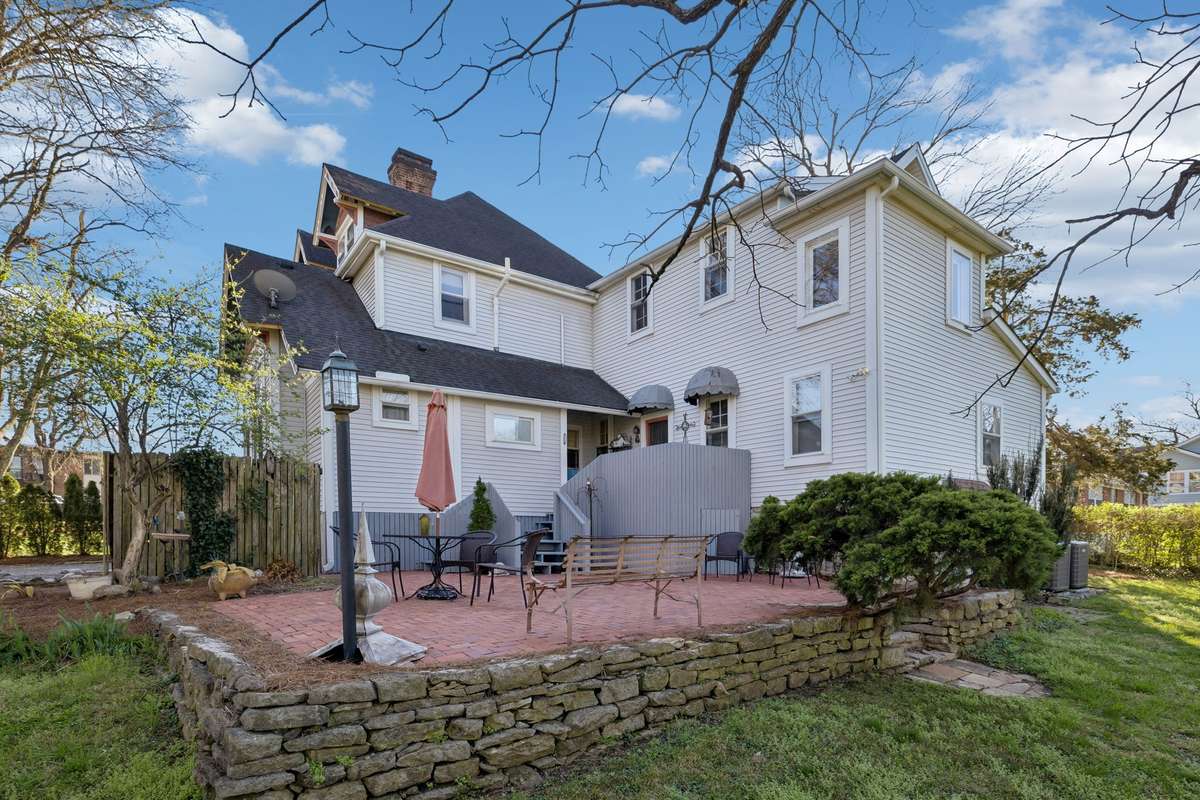 A spacious brick patio to relax and enjoy the birds and the level, sprawling lawn
