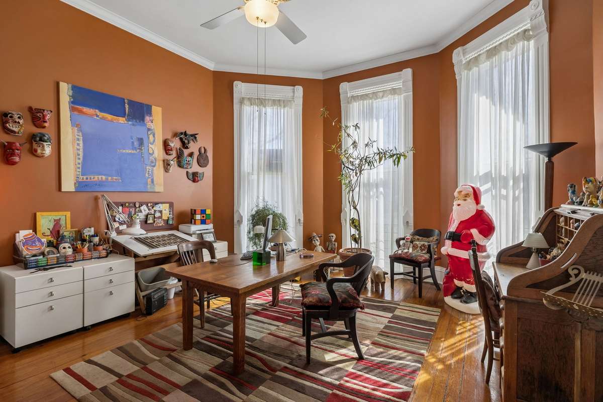 The parlor to the right of the entrance is used as a home office. The large canted bay windows are 10' high, and the ceilings are 11' high.