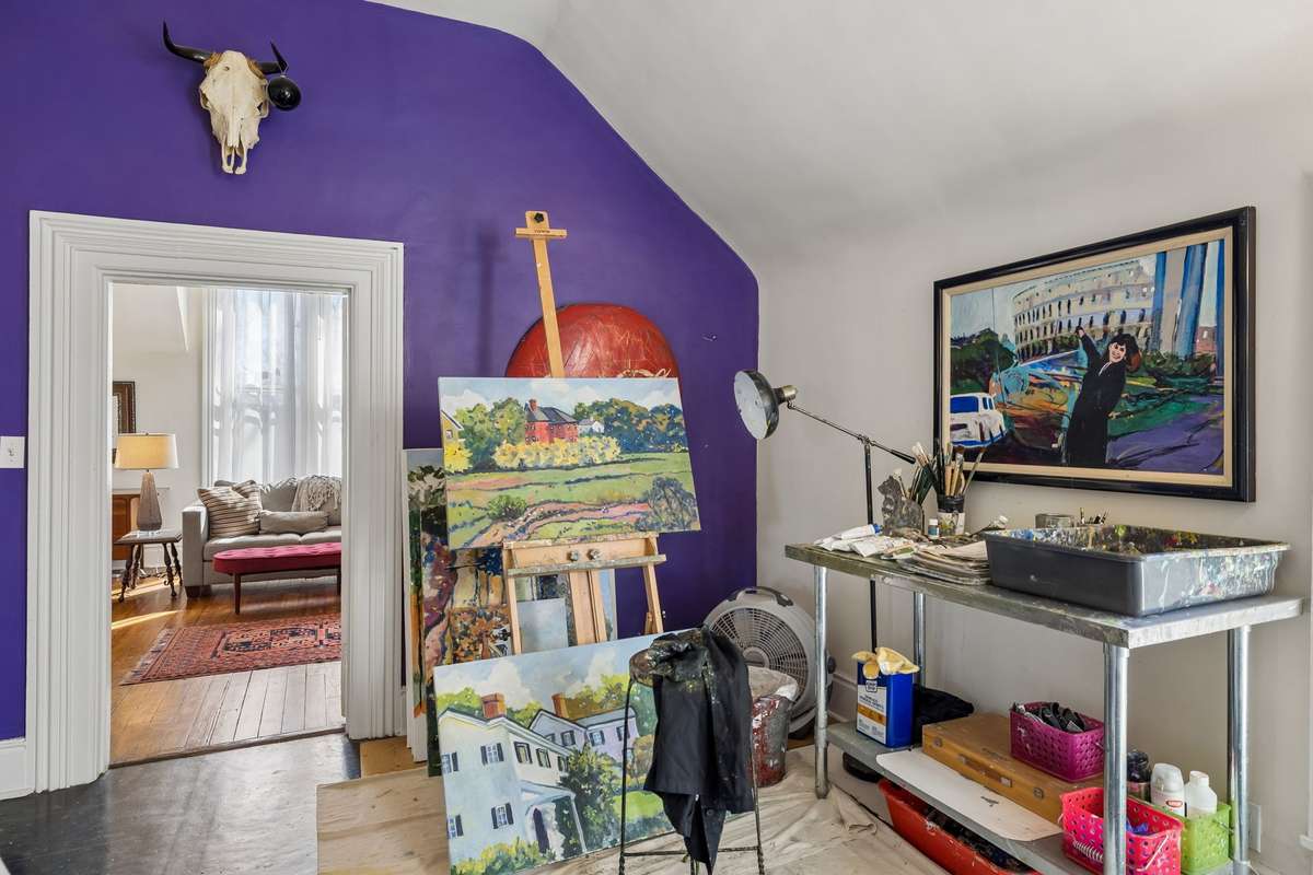 The artist's studio serves as a central hub between two additional bedrooms/living spaces
