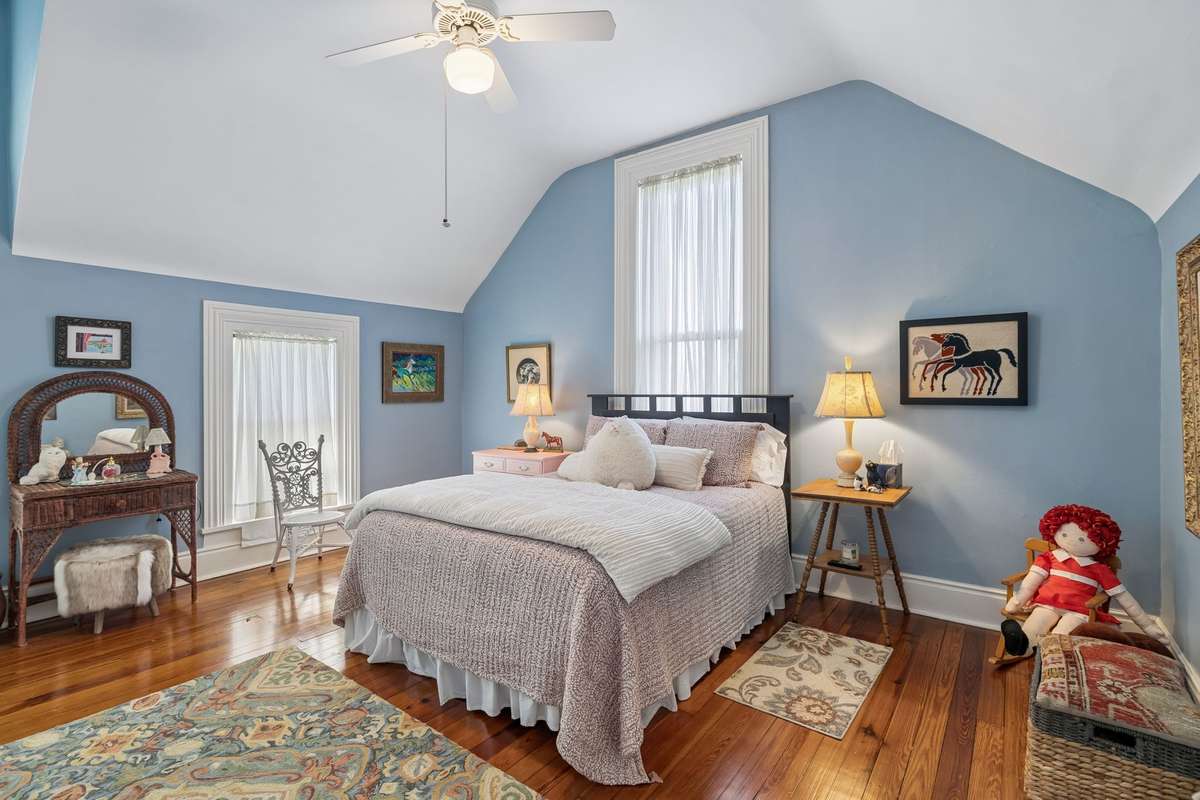Another second-floor bedroom that is adjacent to the large artist's studio, overlooks the beautiful back lawn
