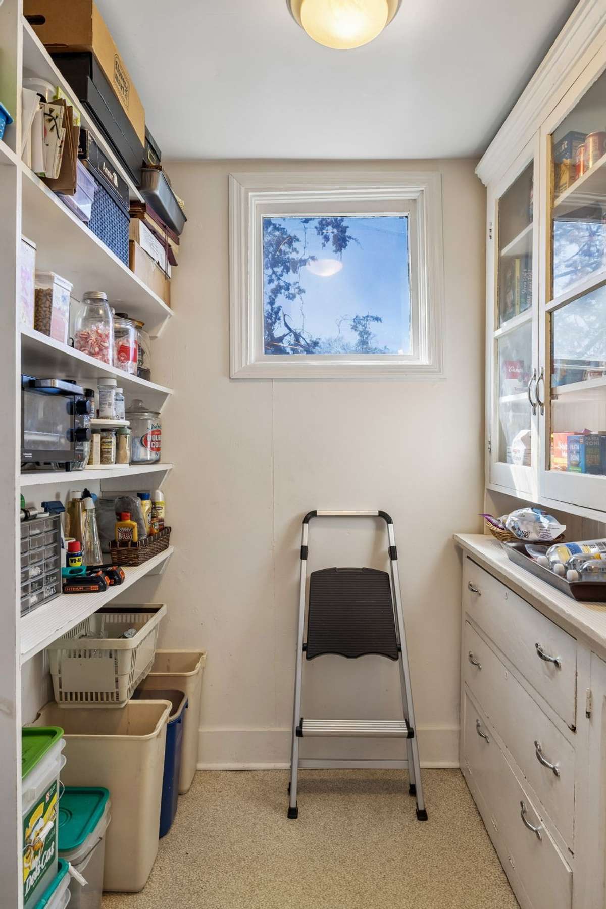 The bedroom closet is being used as a large walk-in pantry. Lots of storage.