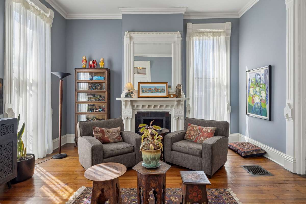 The parlor to the left of the front door is currently used as a living room and has a working gas fireplace