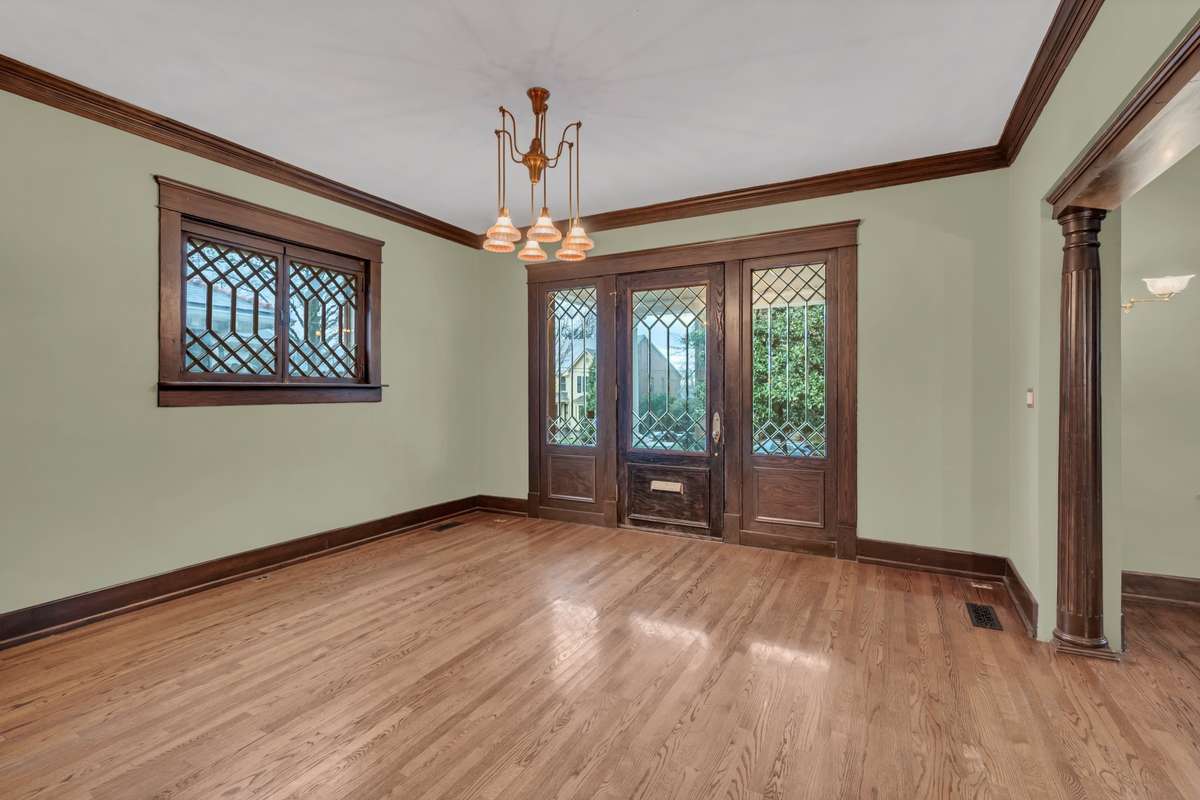 Vintage Chandelier also graces the Entry an abundance of Natural Light Flows into this home
