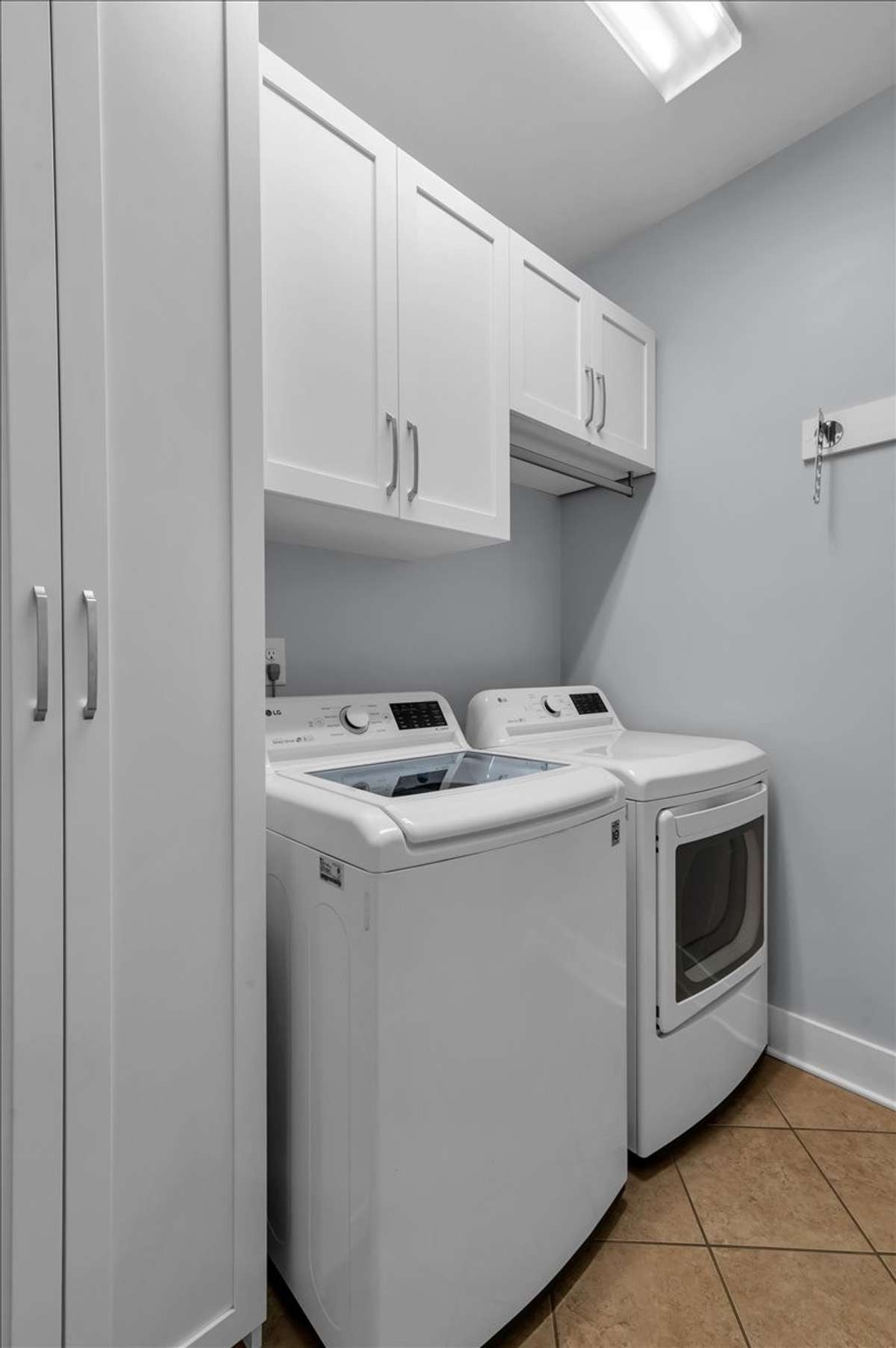 First floor laundry room with custom cabinetry