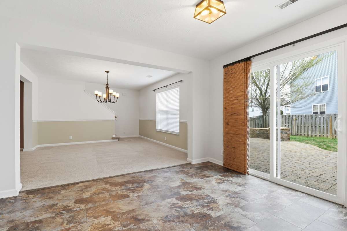 The sliding glass door just off the kitchen allows light and walk out onto an amazing stone patio