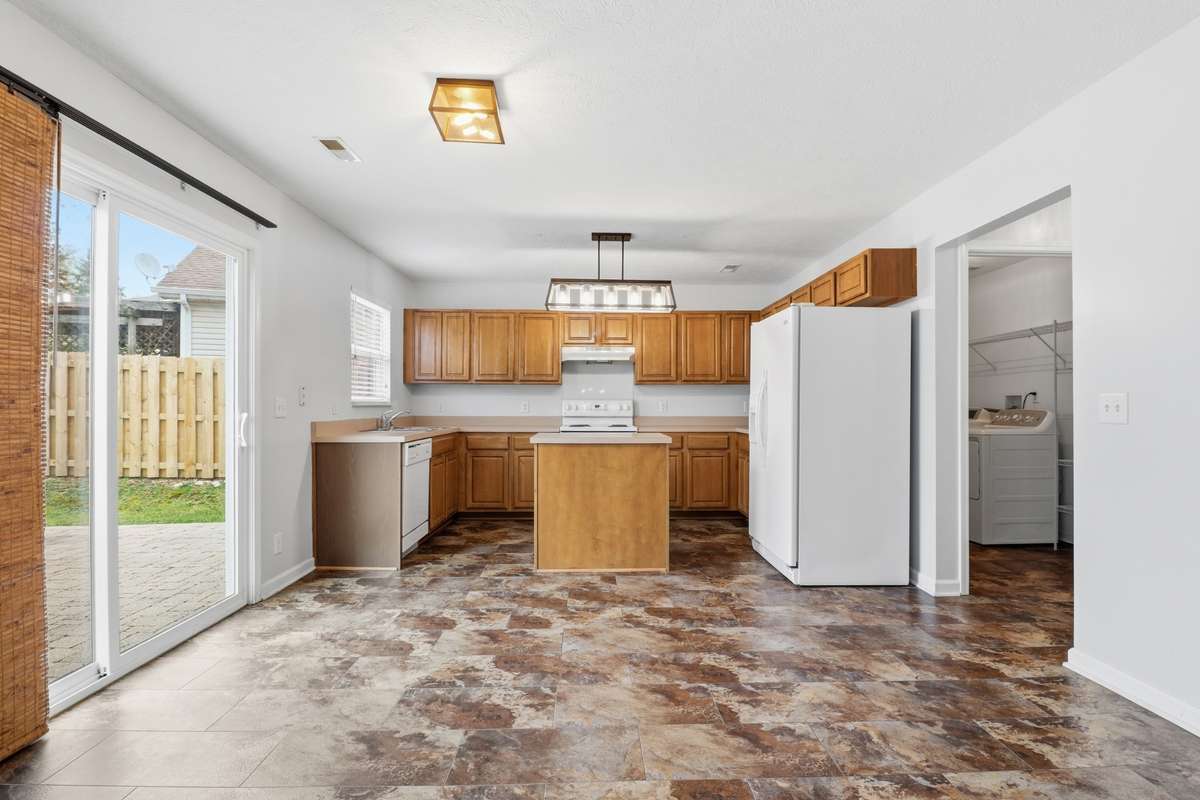 The Kitchen and Breakfast Nook is a nice size with updated light fixture over the Island