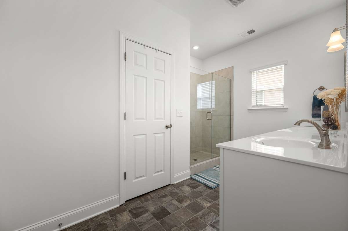 Primary bathroom with dual sink vanity, tile shower, private water closet, and linen closet!