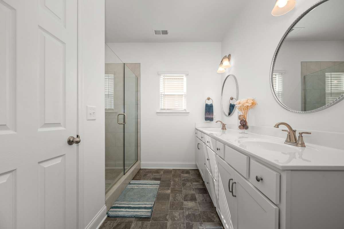 Primary bathroom with dual sink vanity, tile shower, private water closet, and linen closet!