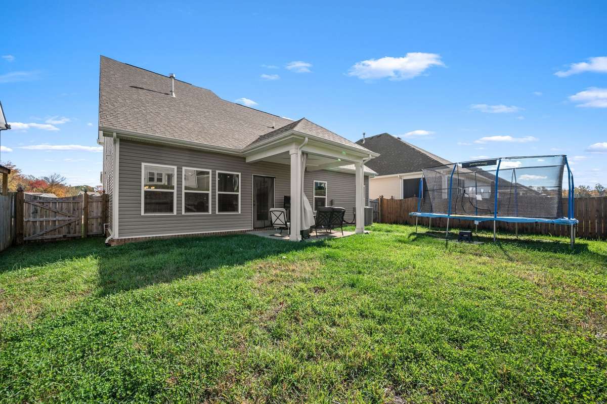 Fully fenced backyard featuring a covered patio!