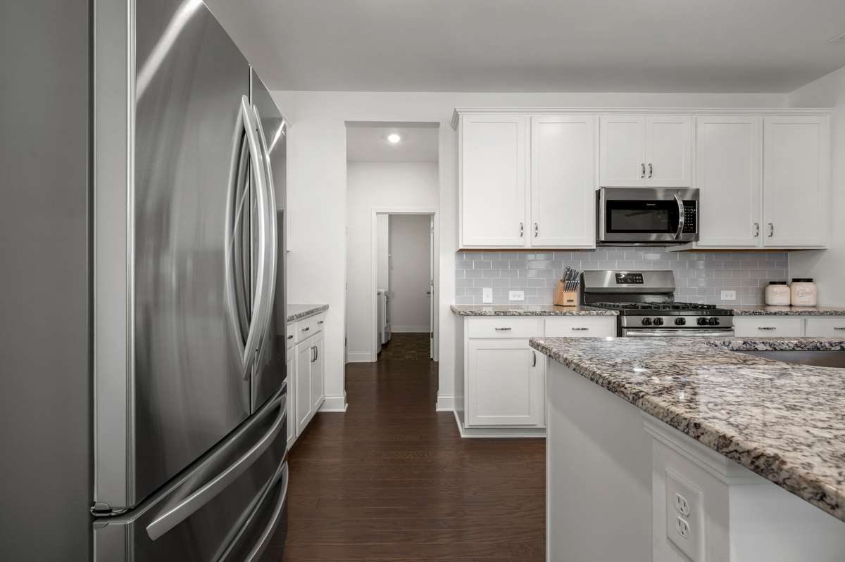 Kitchen hall leads to garage, a spacious laundry room, and pantry!