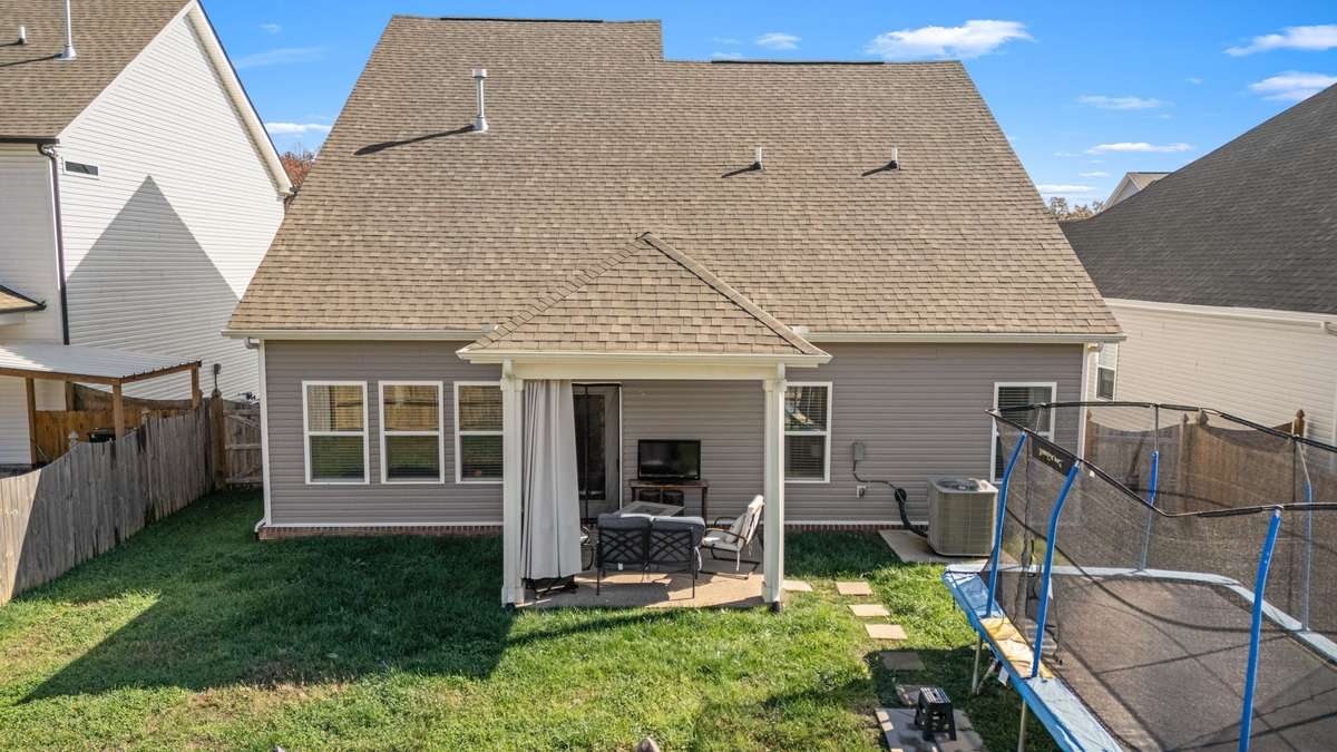 Fully fenced backyard featuring a covered patio!