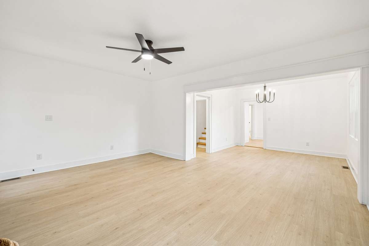Bright, open living room going into spacious dining room with tons of natural light.