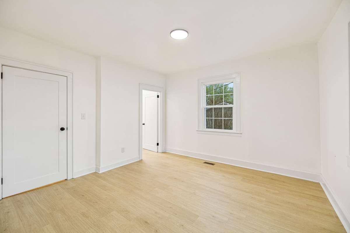 Primary Bedroom features en suite bathroom and new paint and flooring.