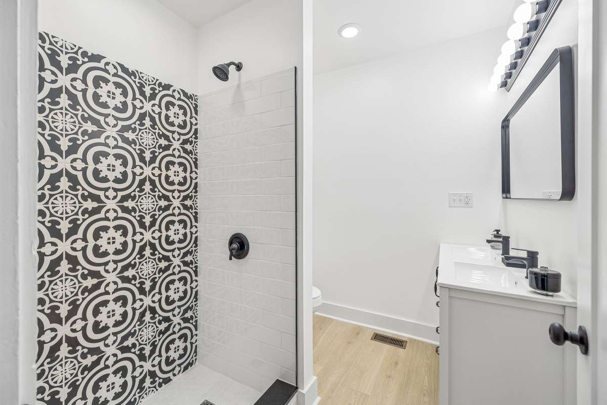 Primary bath with tile shower and new vanity.