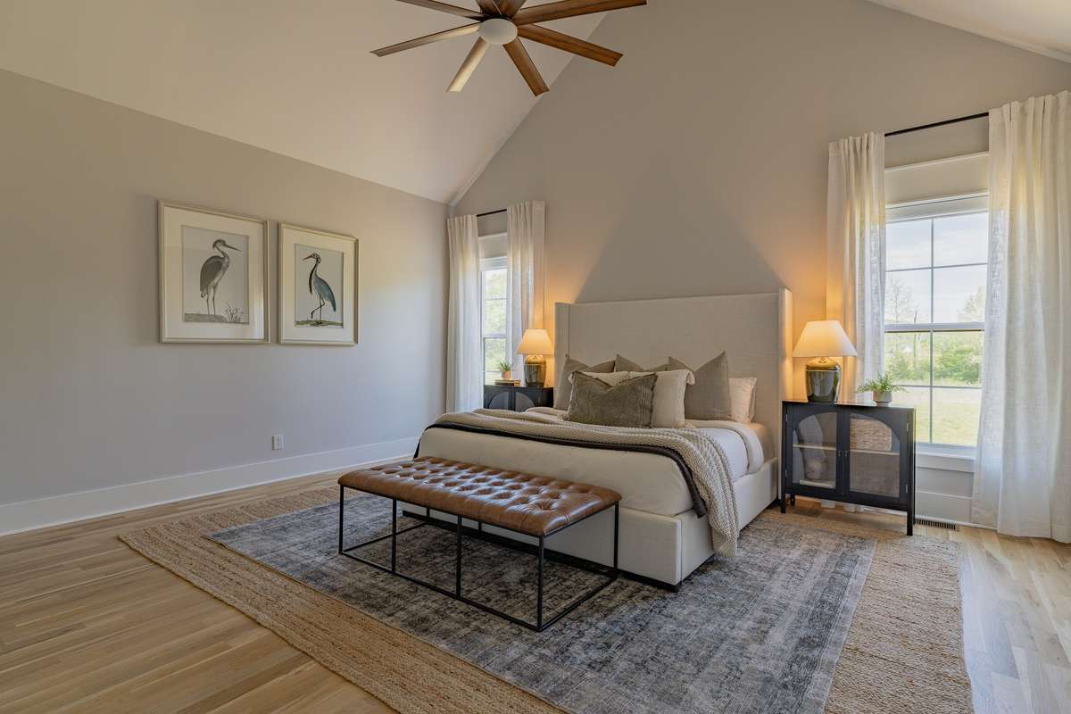 Primary Bedroom has Vaulted Ceilings and Custom Bloomin Blackout Blinds by Norman (these blinds are over $750 per window and give you total blackout)