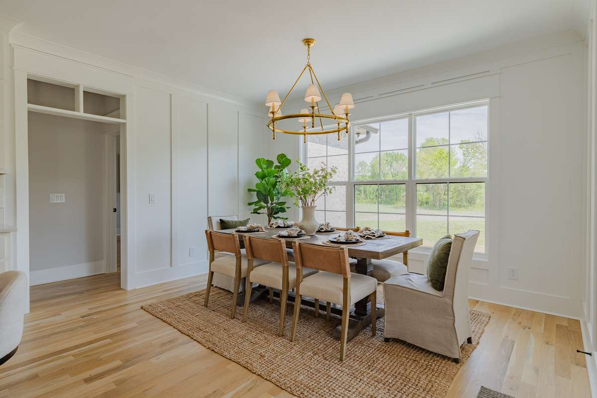 Stunning Dining Room with Custom Millwork, Visual Comfort Chandelier and LOTS of Natural Light!