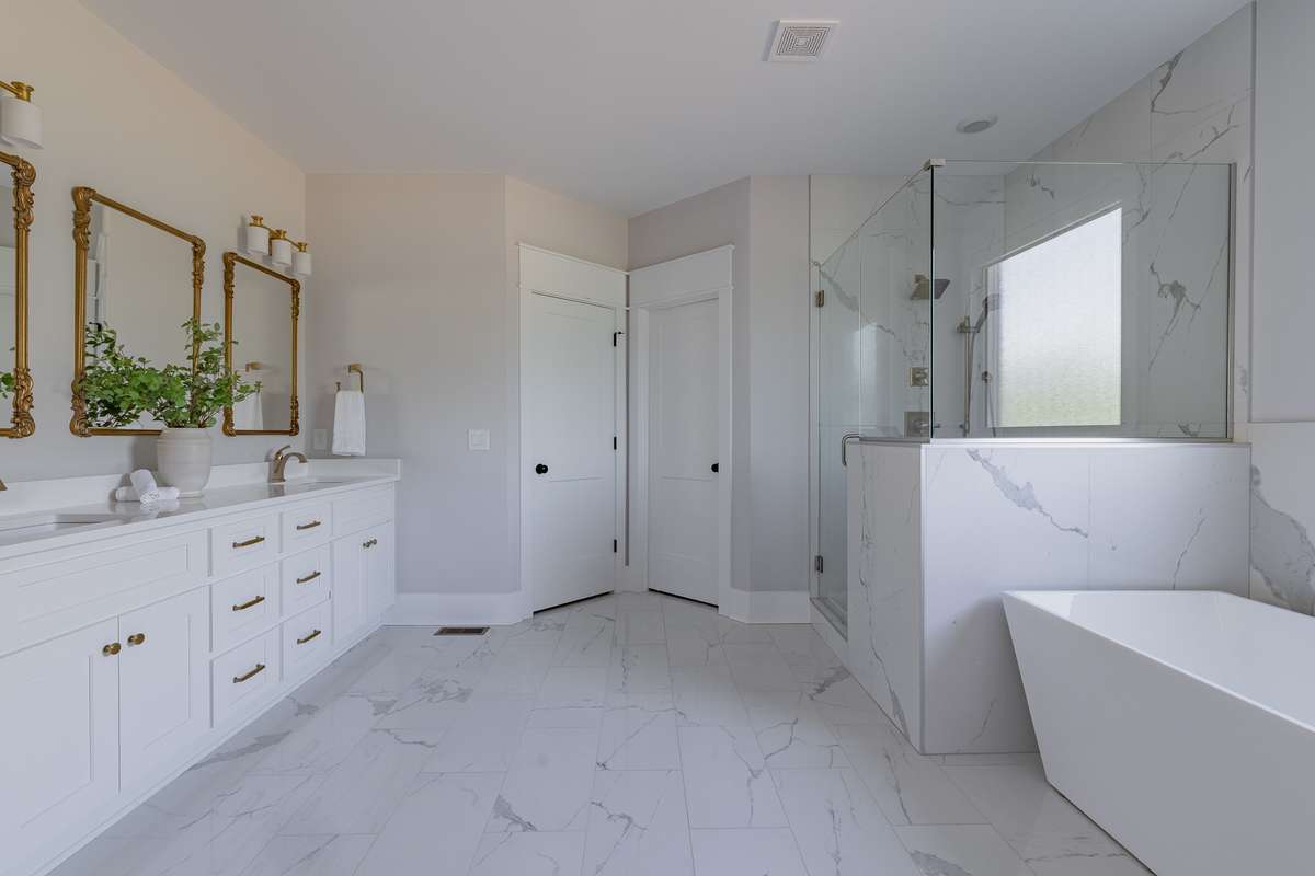 Huge Primary En-Suite with Oversized Shower with 2 Shower heads, Large Soaking Tub, Double Vanities, Private Water Closet and an Oversized Walk-In Closet (connected to the Laundry Room)