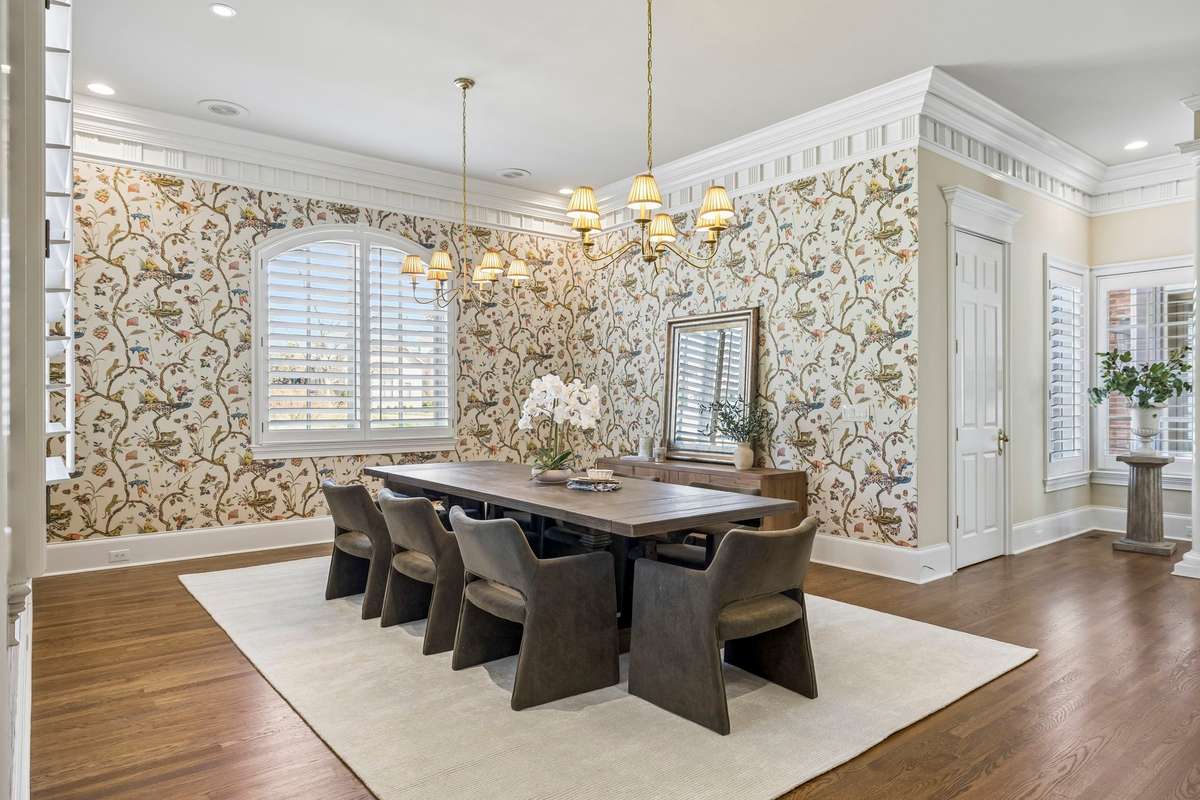 Formal dining room with ornate molding and designer wallcovering