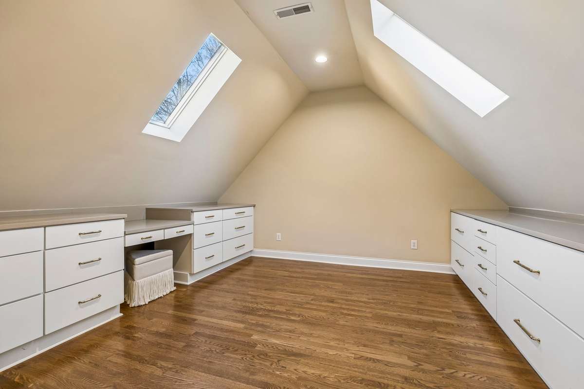 Private upstairs office/flex space with skylights and built-in workspace