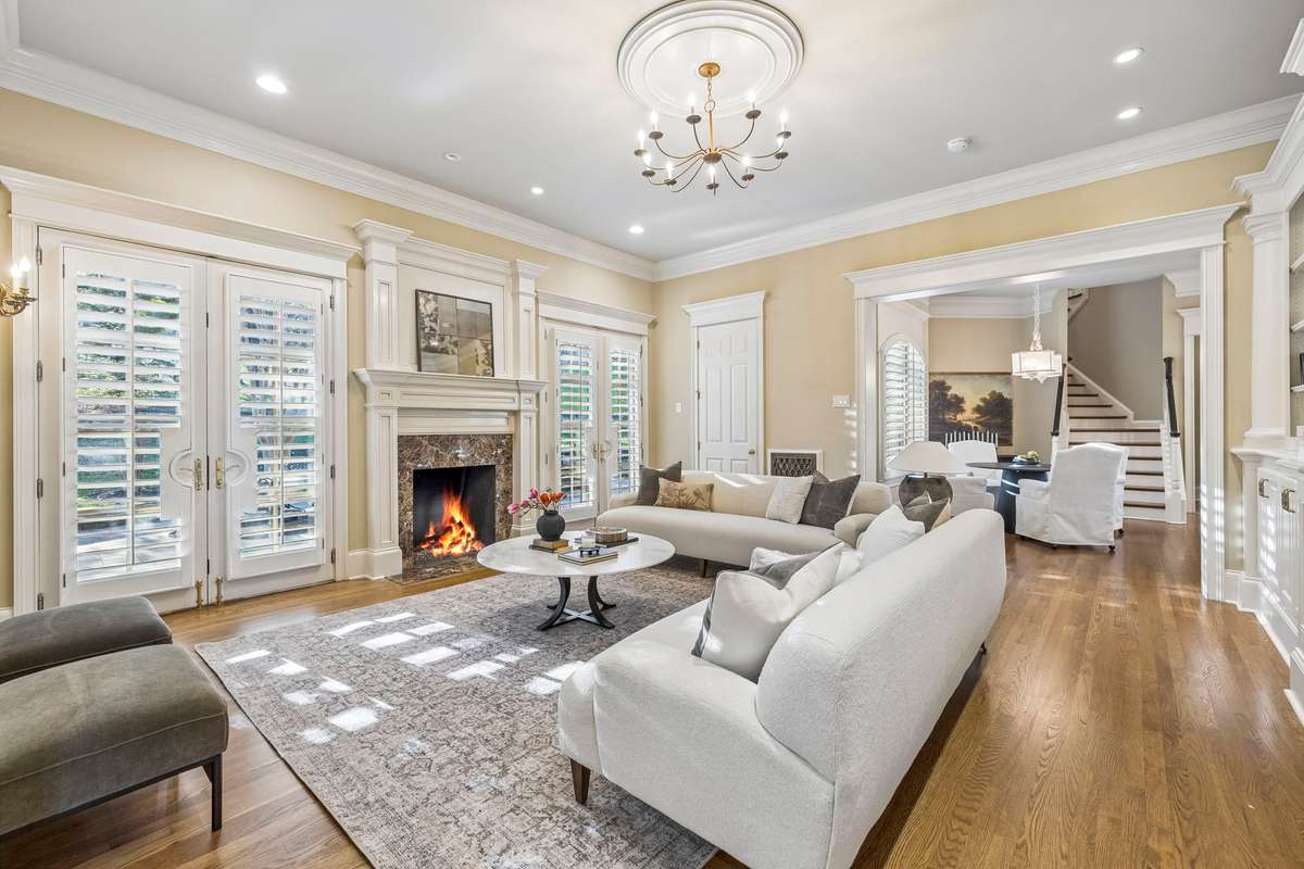 Spacious den with gas fireplace, custom built-ins, and French doors for seamless outdoor access