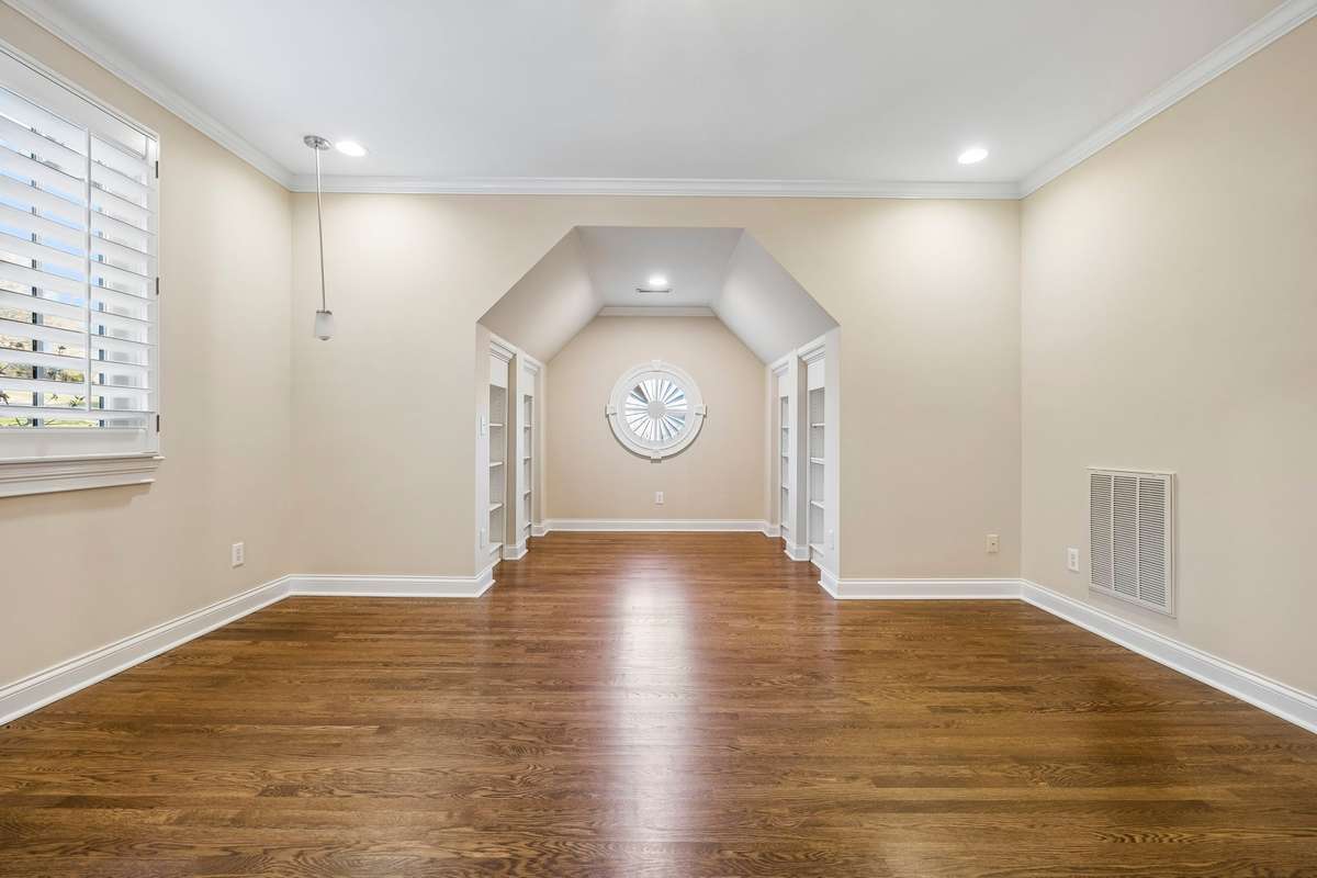 One of three spacious bedrooms with en-suite bath, walk-in-closet and hardwood floors