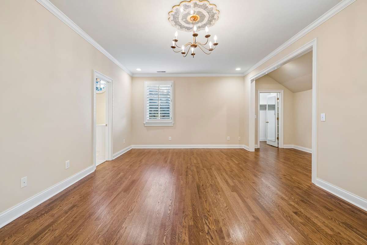 One of three spacious bedrooms with en-suite bath, walk-in-closet and hardwood floors