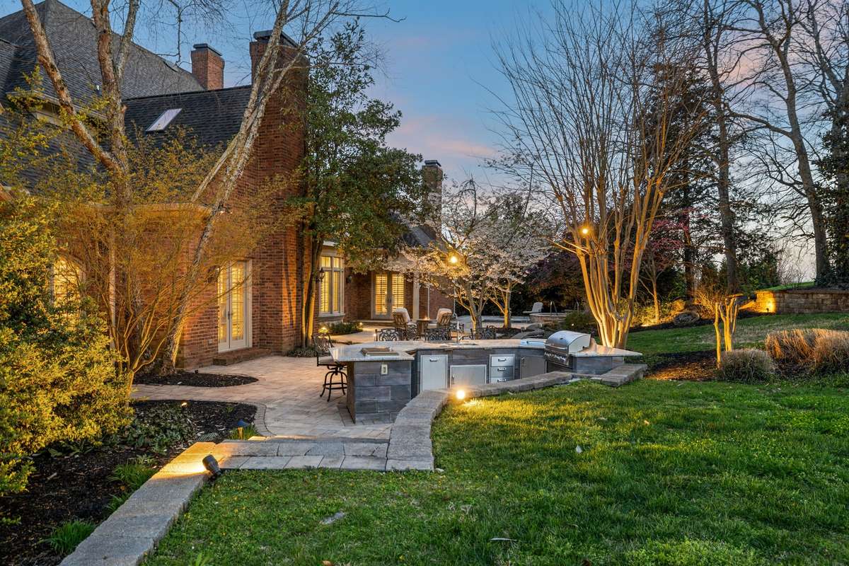 Fully equipped outdoor kitchen with built-in gas grill, 2-burner gas cooktop, prep sink, ice box and beverage cooler