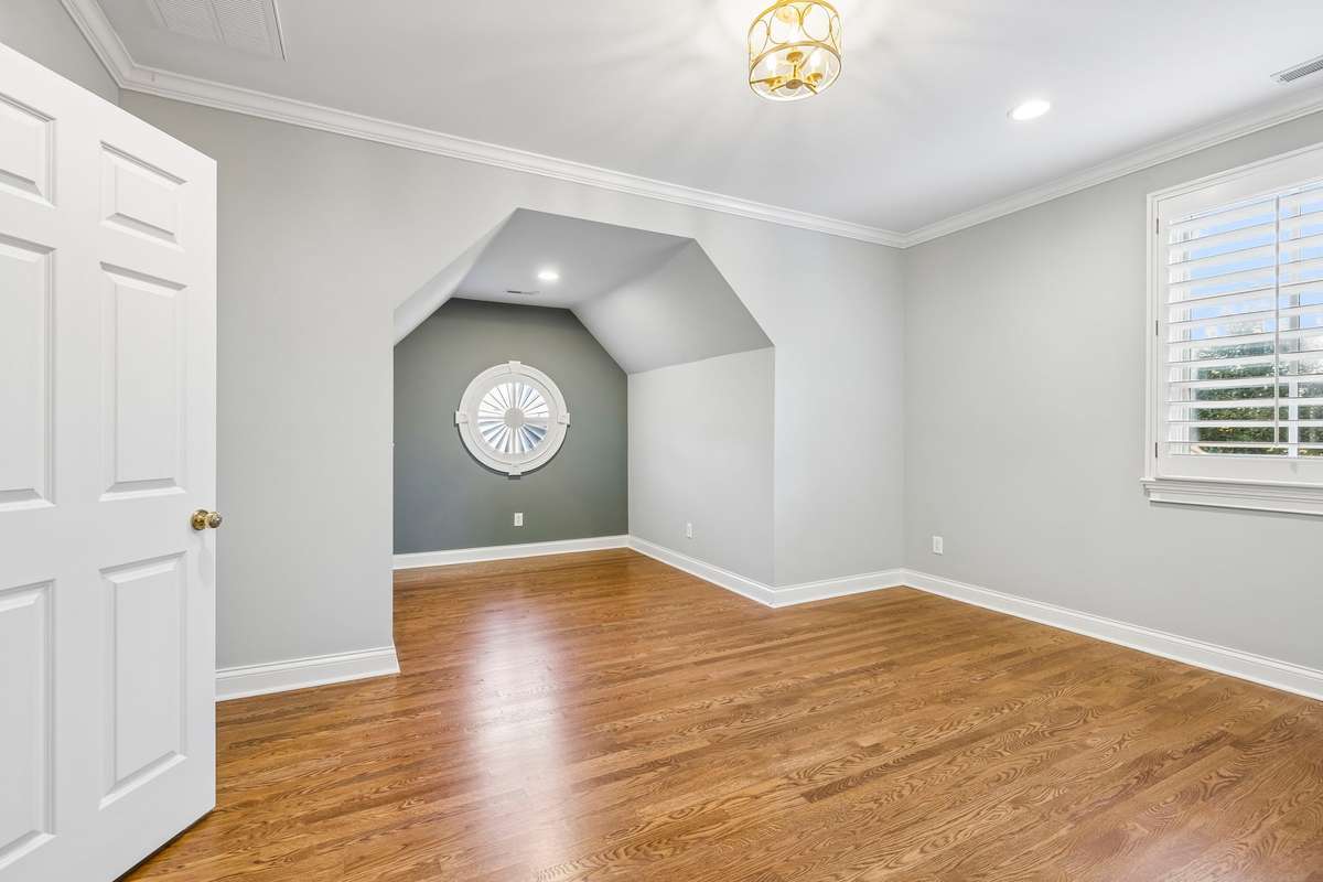 One of three spacious bedrooms with en-suite bath, walk-in-closet and hardwood floors