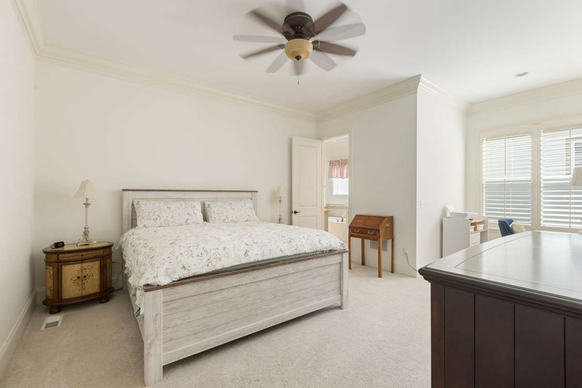 Spacious primary bedroom with additional seating nook or work space