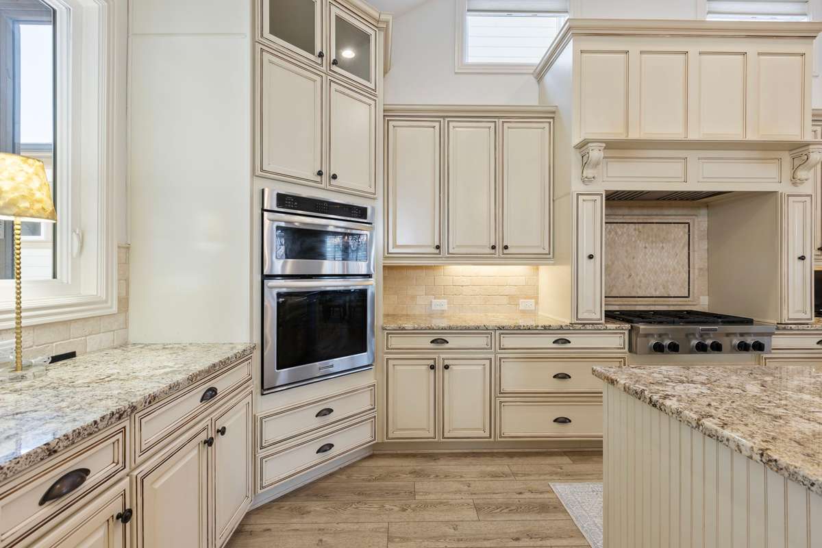 The chef's kitchen features under-cabinet lighting and premium appliances