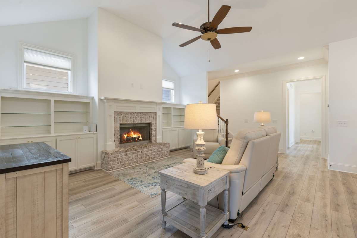Spacious living room with vaulted 13’ ceiling and gas fireplace