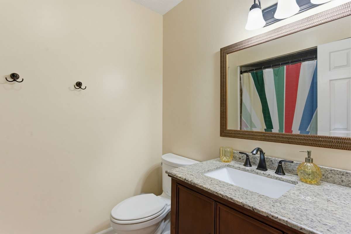 Upstairs full bath in hallway between second and third bedrooms.