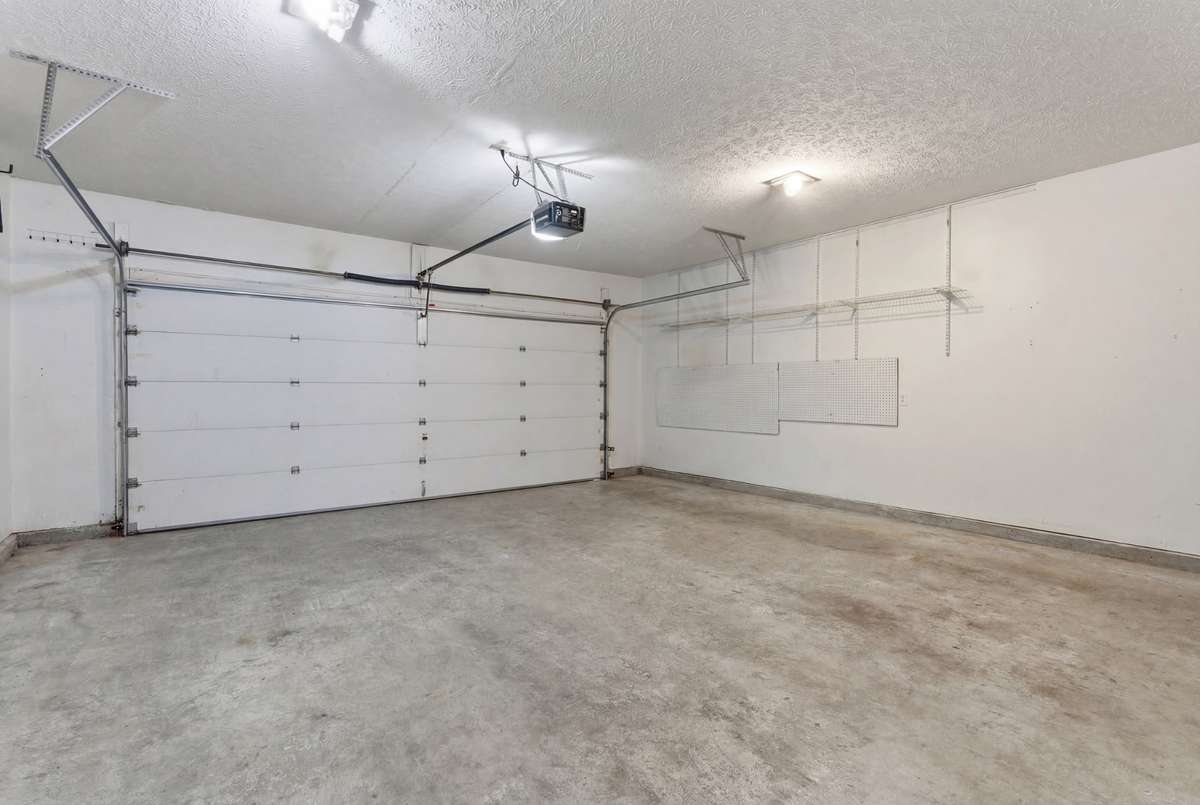 Large two-car garage looking from kitchen entrance door.