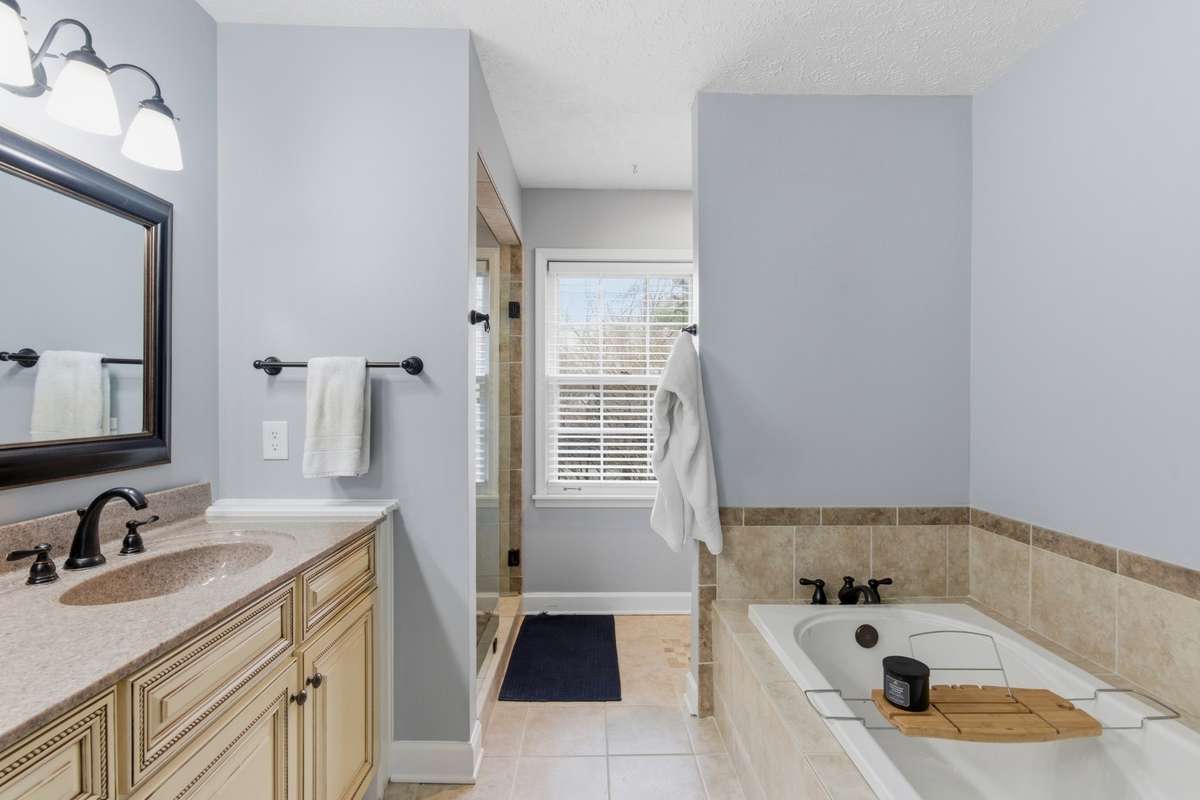 Primary bathroom showing standalone tub. Shower to the left in rear. Toilet in rear to right.