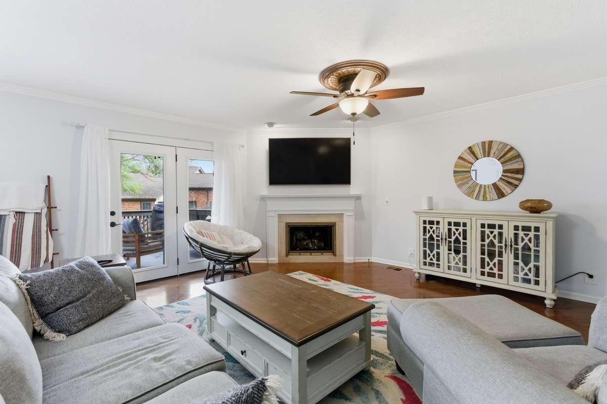 This Brentwood condo features a spacious living room with doors to downstairs deck and gas fireplace.