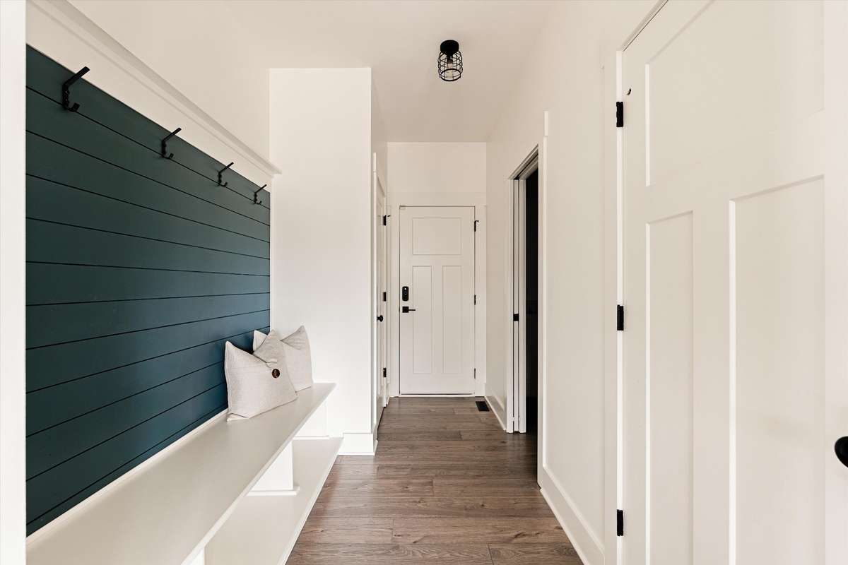 A thoughtfully placed mudroom at the garage entrance, with the laundry just across and easy access to the kitchen